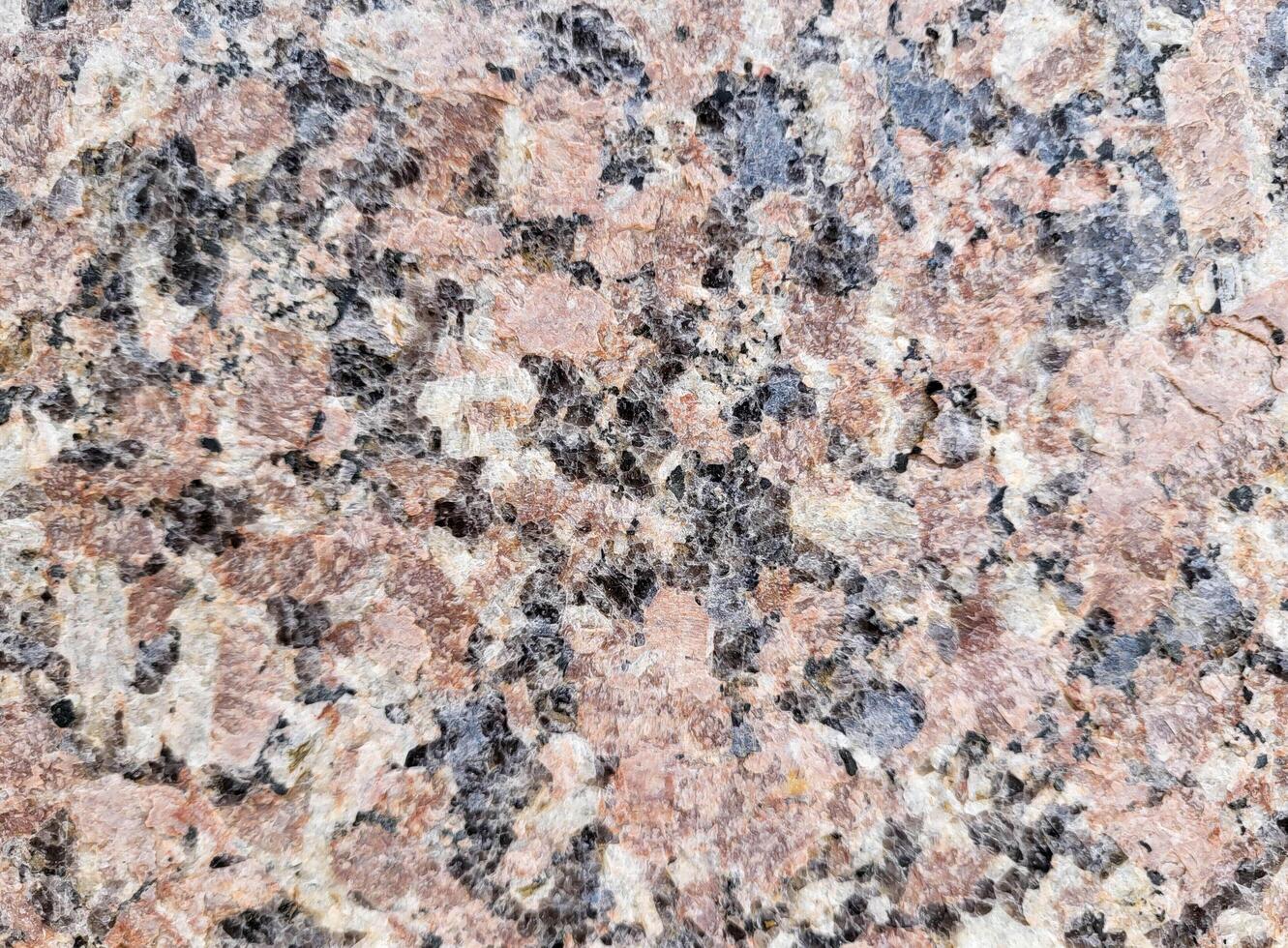 Close-up of the facade of the building, lined with pink marble slabs. Paving slabs in daylight. Natural colors photo
