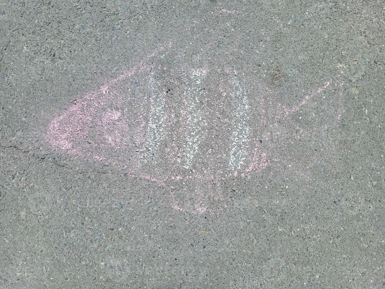 Pink fish painted in chalk on the asphalt. photo