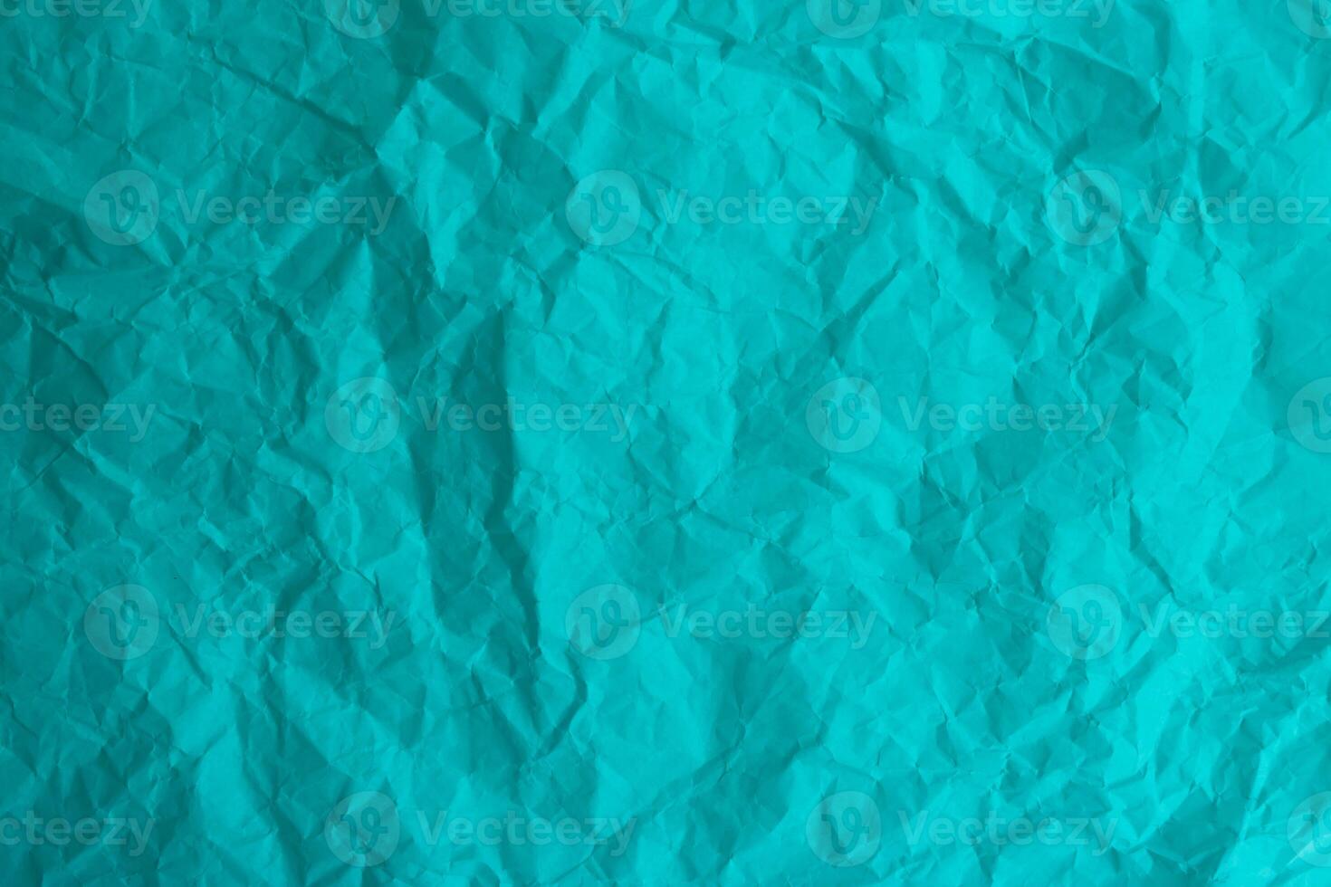 Turquoise abstract light background made of crumpled paper photo