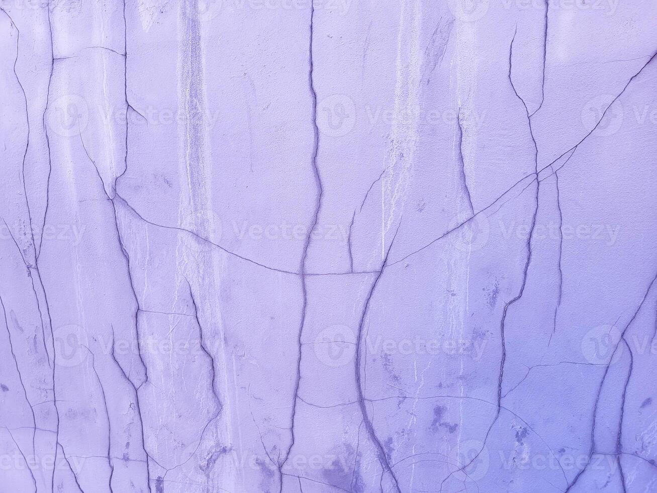 The purple plastered wall of the facade , cracked after the rain photo