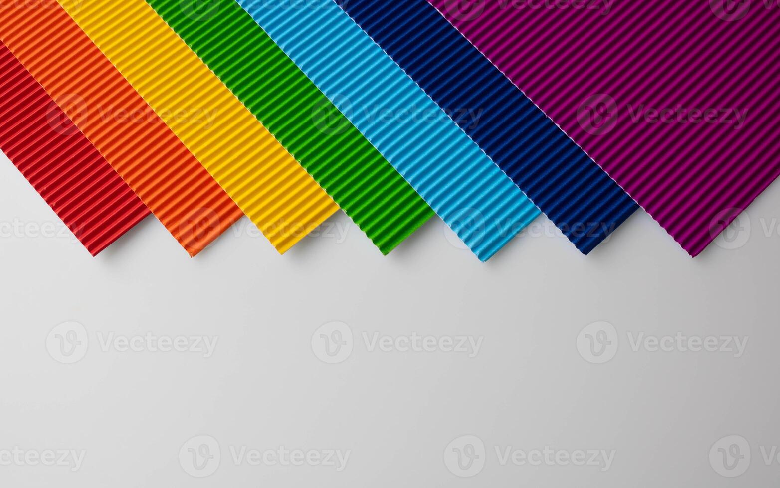 Background of multicolored corrugated colored paper with a place for text. photo