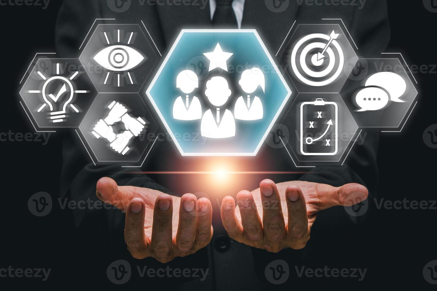 Hands presenting leadership icons symbolizing teamwork, vision, and strategy in a modern business context. photo