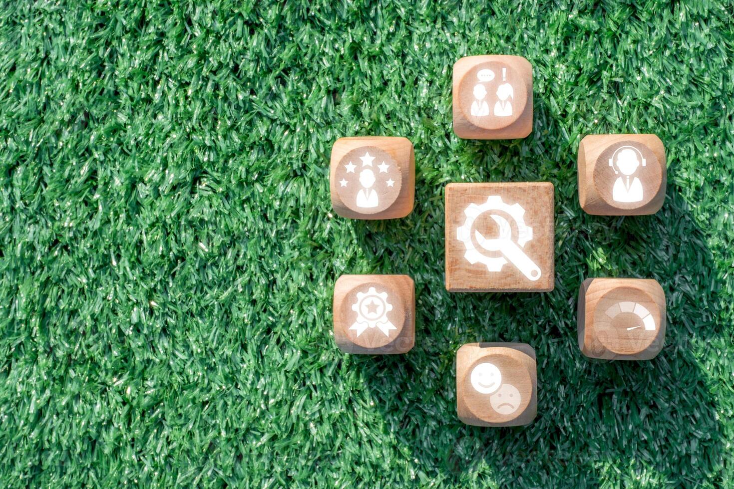 Wooden blocks with service icons on grass, symbolizing customer support, satisfaction, and innovative service concepts. photo