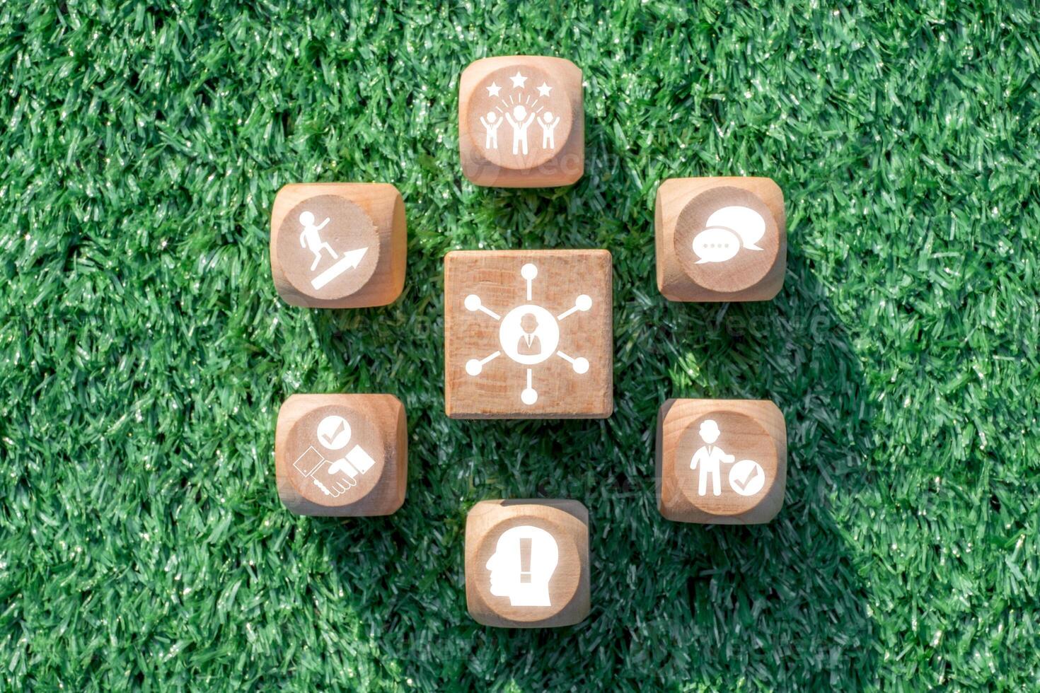 Wooden blocks on grass symbolize essential soft skills like communication, teamwork, and leadership in a modern workplace. photo