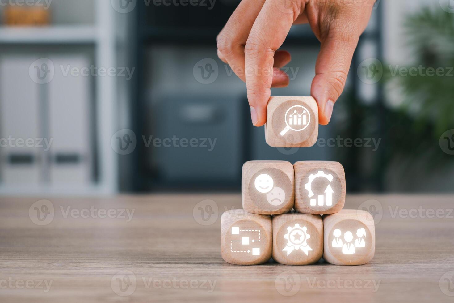 Wooden blocks with icons symbolizing quality control, efficiency, and performance in business settings. photo