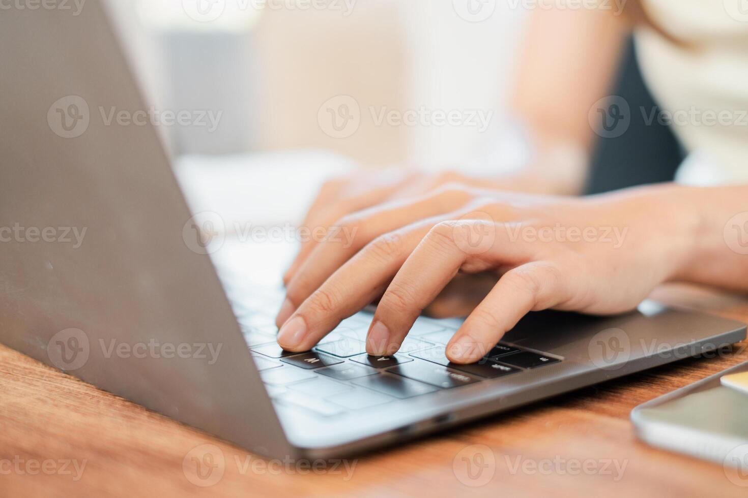 Hands typing on a laptop keyboard in a well-lit workspace, ideal for business, education, or remote work themes. photo