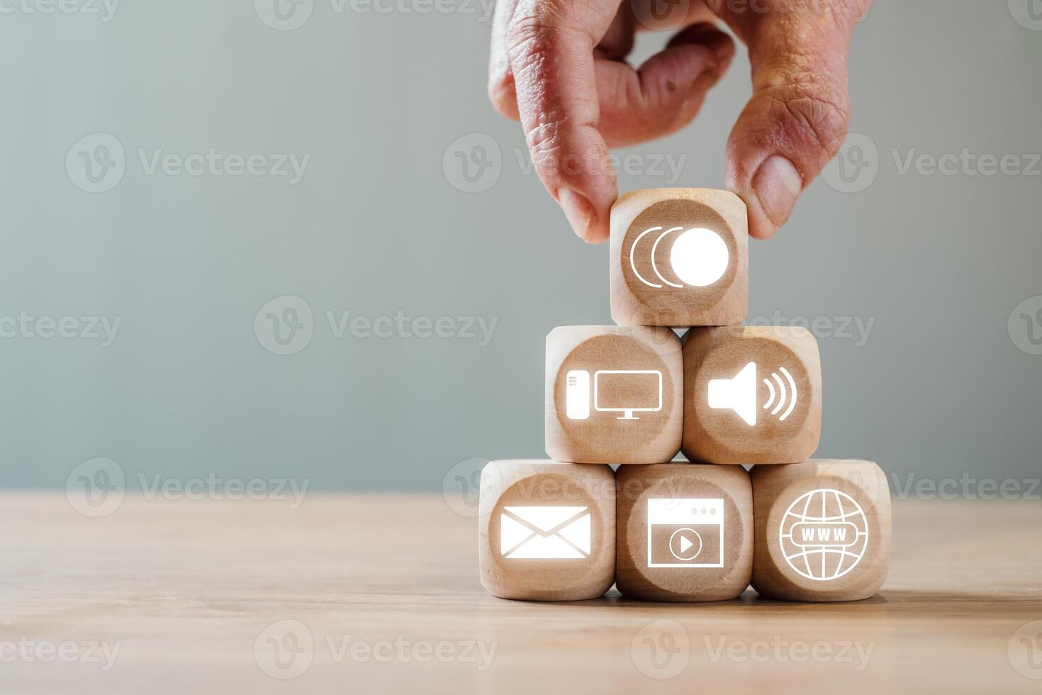 Wooden blocks with digital icons symbolize multimedia communication and technology in a modern setting. photo