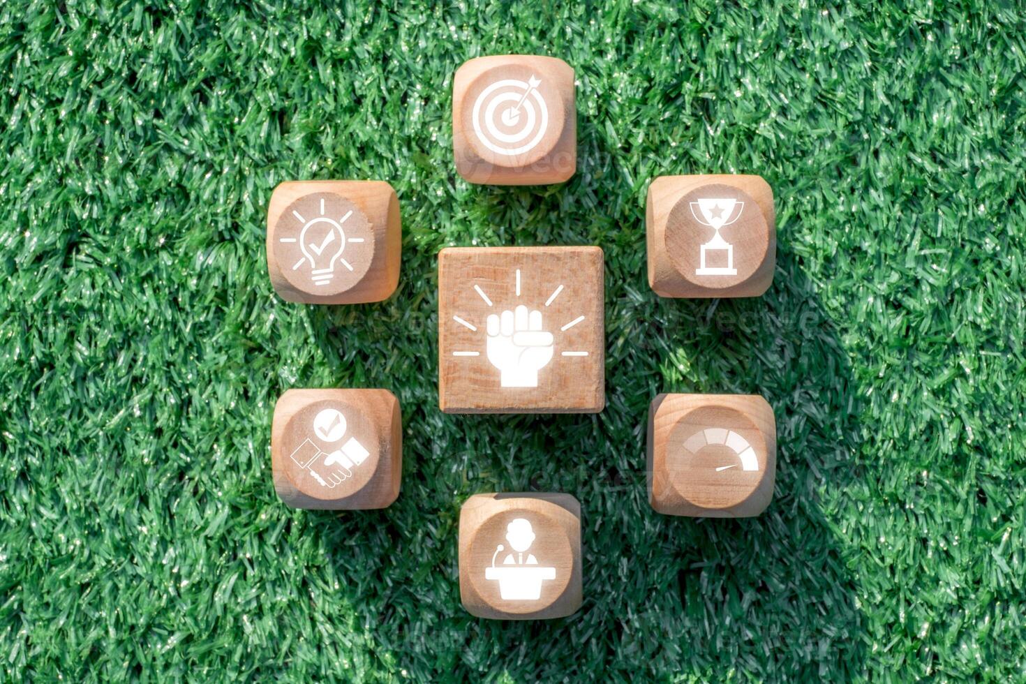 Inspiring Motivation Concept with Wooden Blocks and Icons on Green Grass Background for Success and Achievement photo