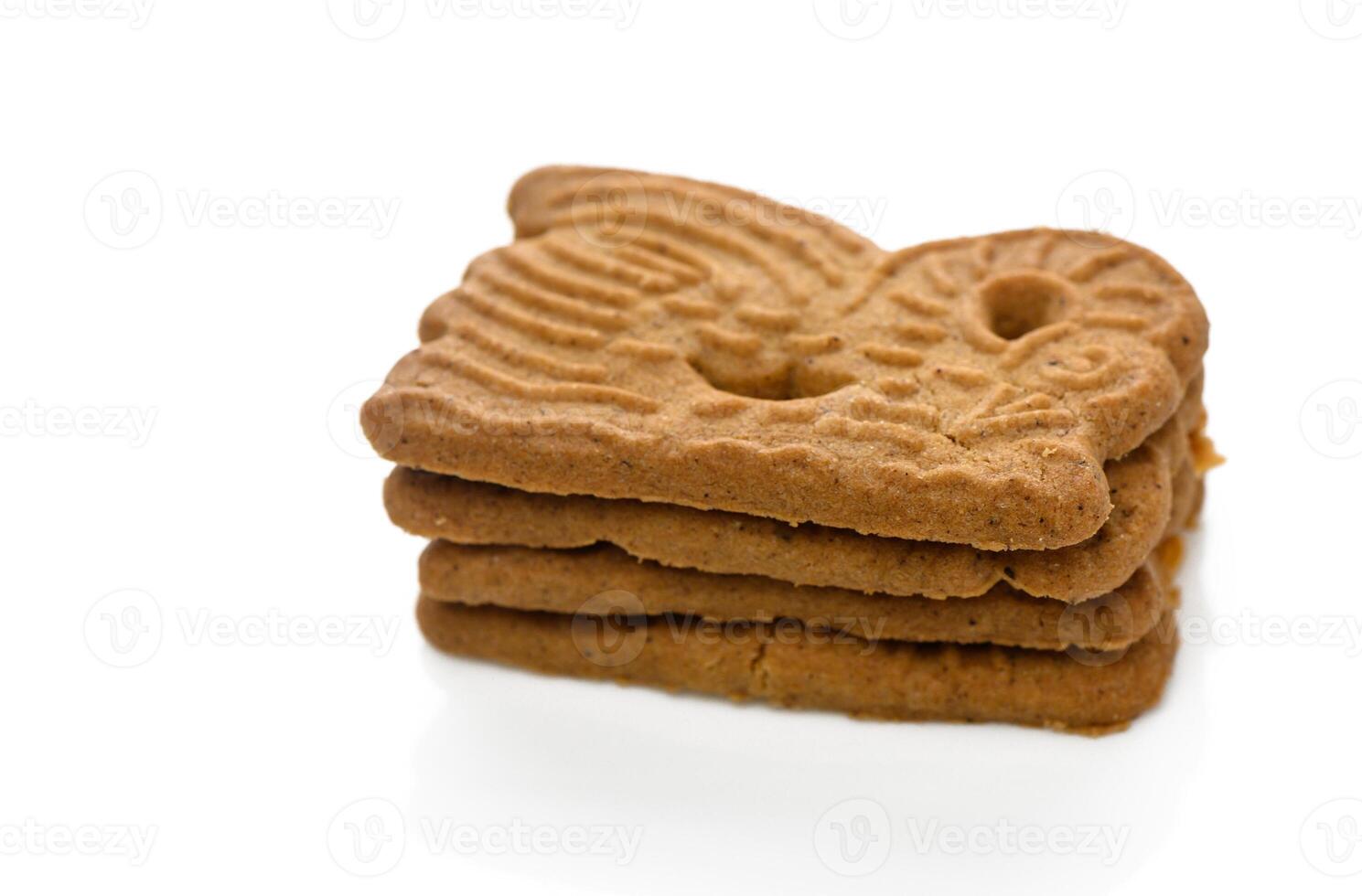 Gingerbread cookies stacked artfully on a white background capturing their intricate designs photo