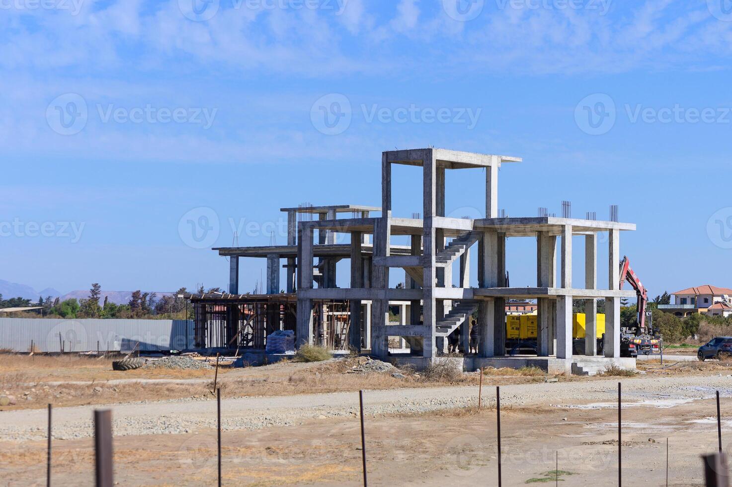 New construction progress on a modern building under clear blue skies in a developing neighborhood photo
