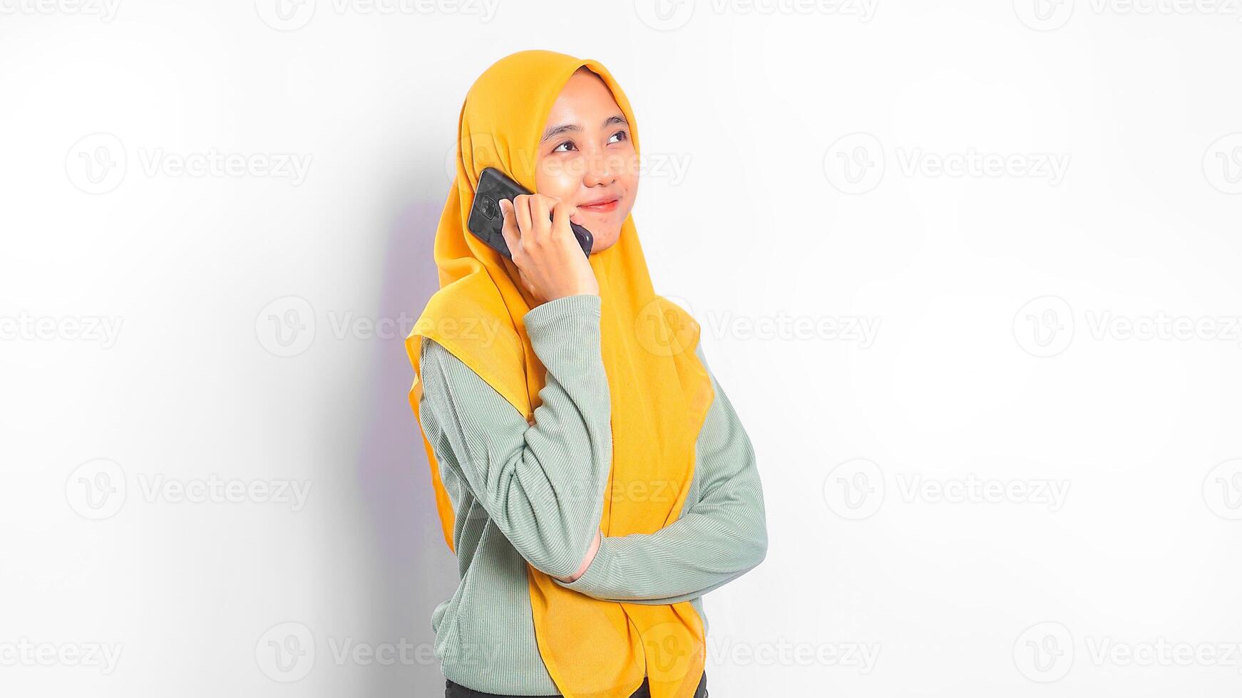 Asian Woman Wearing Hijab Talking on the Phone photo