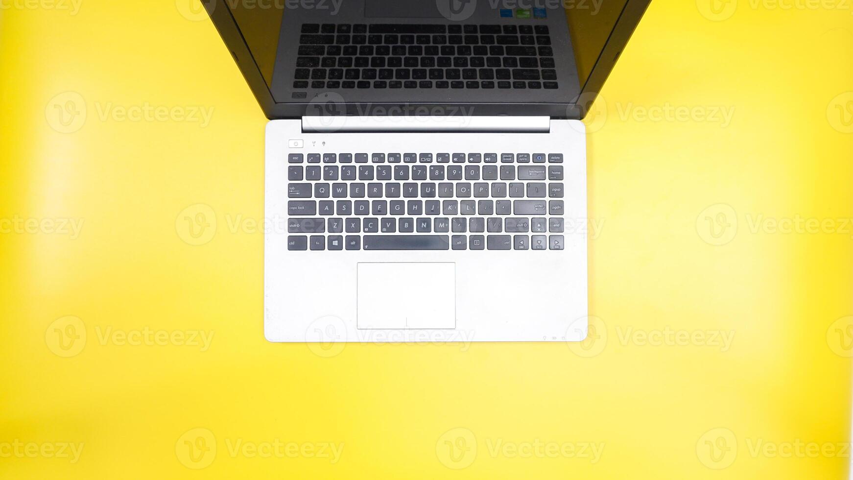 Top View of Laptop isolated on Yellow Background photo