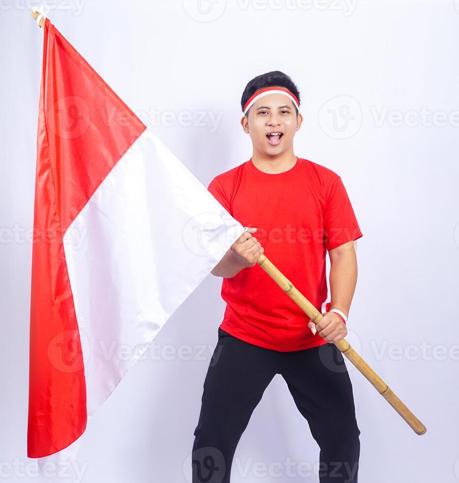 Handsome Indonesian Young Man Holding Country Flag to Celebrate Independence Day of Indonesia photo