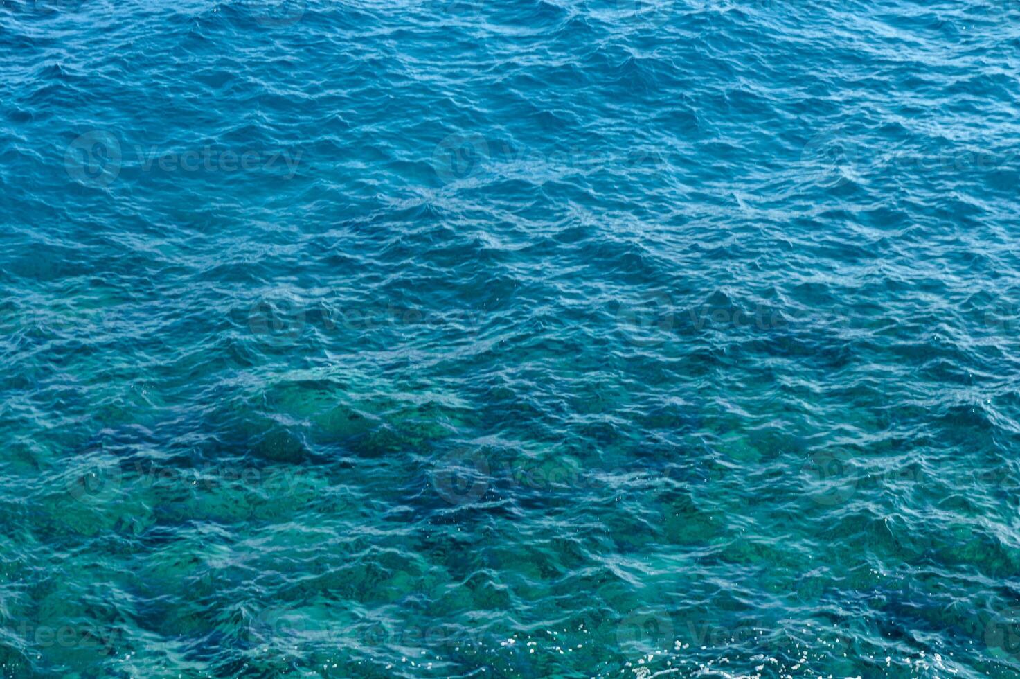 Captivating turquoise waters shimmering under the sunlight along the serene coastline. photo
