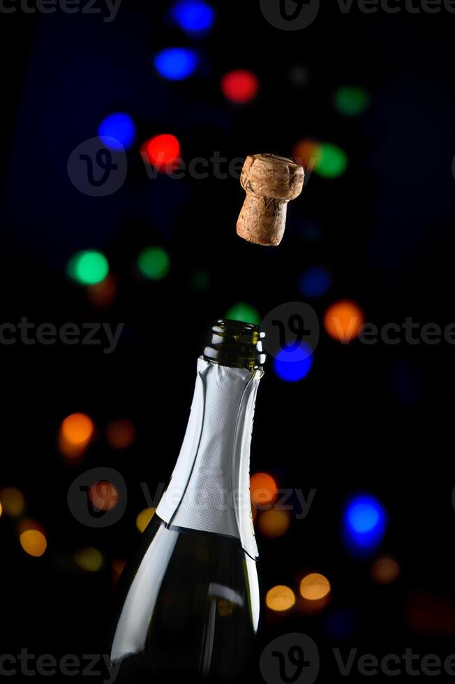 Celebrate the moment with champagne cork popping against festive bokeh lights in the background photo