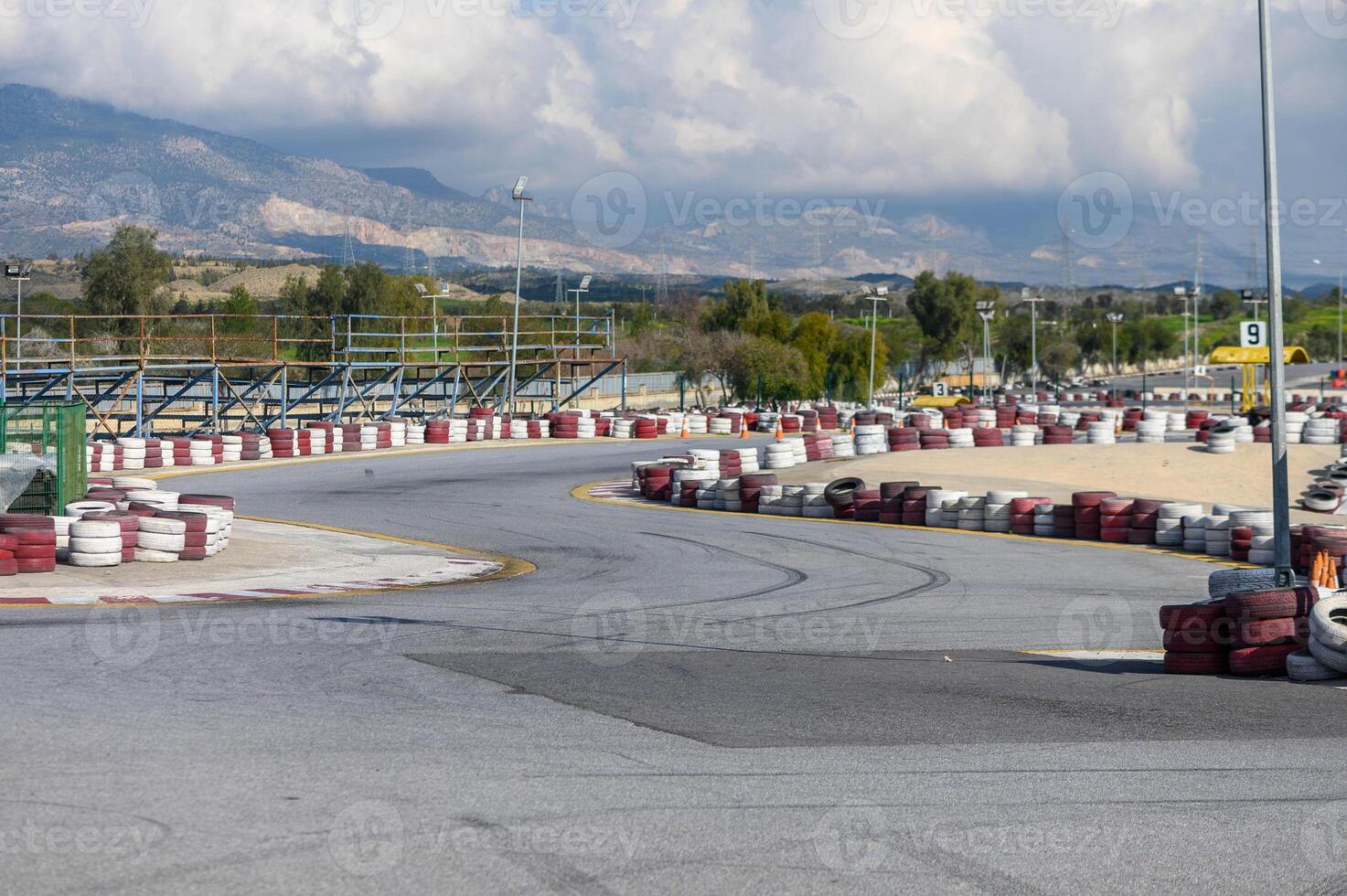 Exciting kart racing track curves around breathtaking mountain landscape in sunny afternoon photo