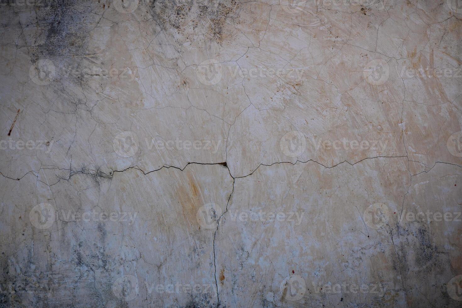 Cracked plaster wall revealing the passage of time in a rustic setting photo