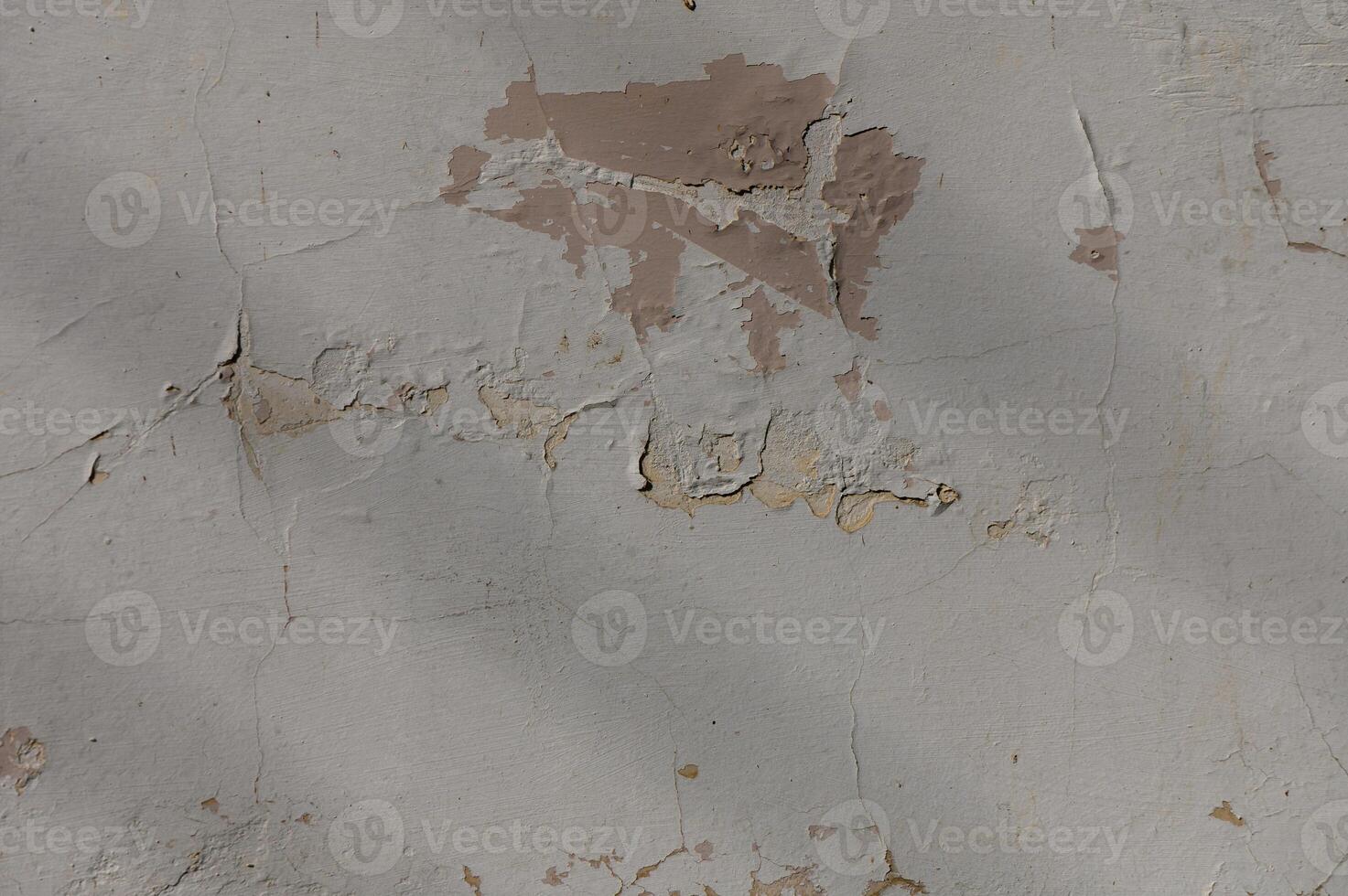 Cracked and peeling wall reveals layers of history in urban decay photo