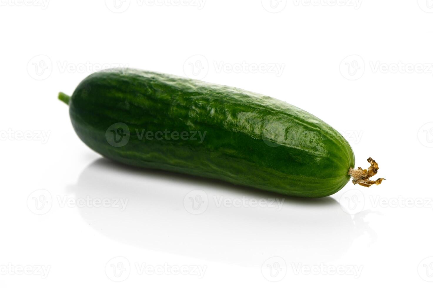Fresh green cucumber resting on a clean surface ready for culinary creations and healthy snacks photo
