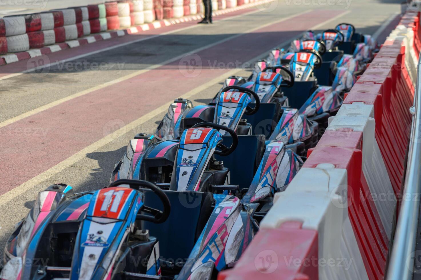 Exciting go-kart lineup awaits racers on a vibrant track in the heart of the city photo