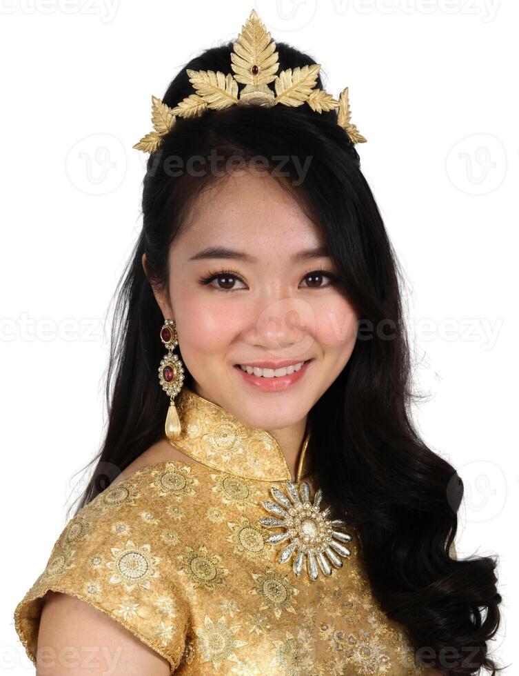 A beautiful young woman wearing a gold dress and tia photo