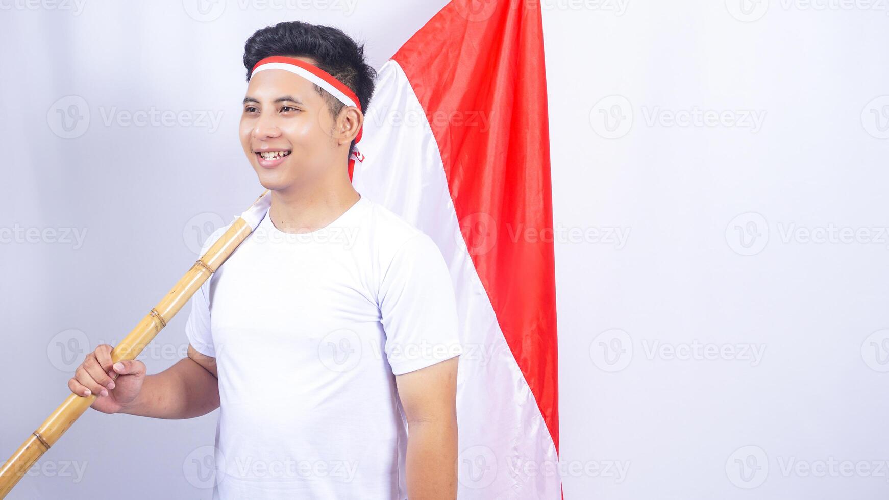 Handsome Indonesian Young Man Holding Red and White Indonesia Flag photo