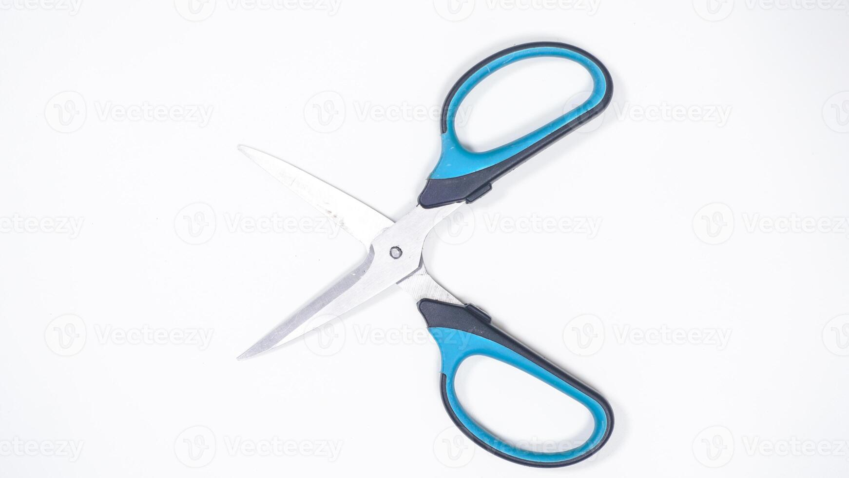 Top View of Open Scissor with Blue and Black Handle Isolated on White Background photo