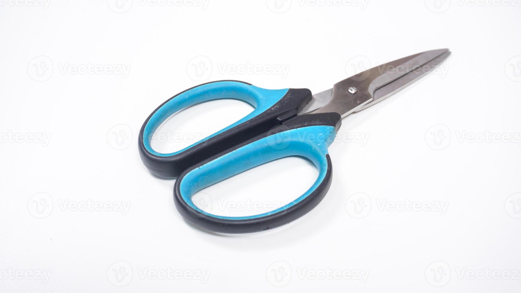 Scissor with Black and Blue Handle Isolated on White Background photo