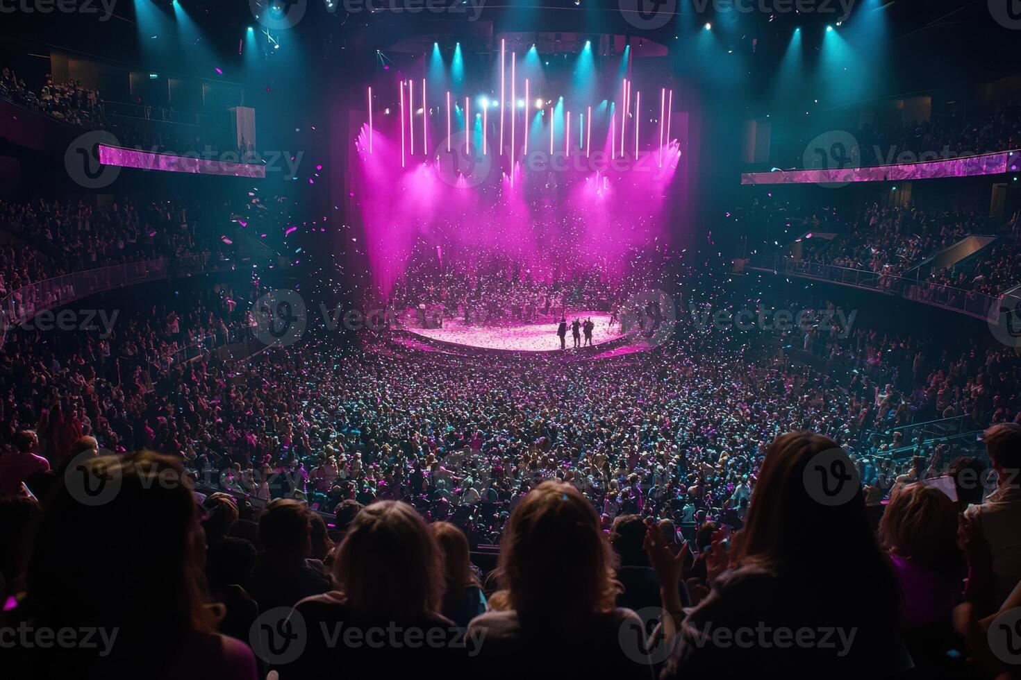An Enthralling Concert Experience A Massive Crowd Roars with Excitement as Confetti Rains Down on the Stage photo