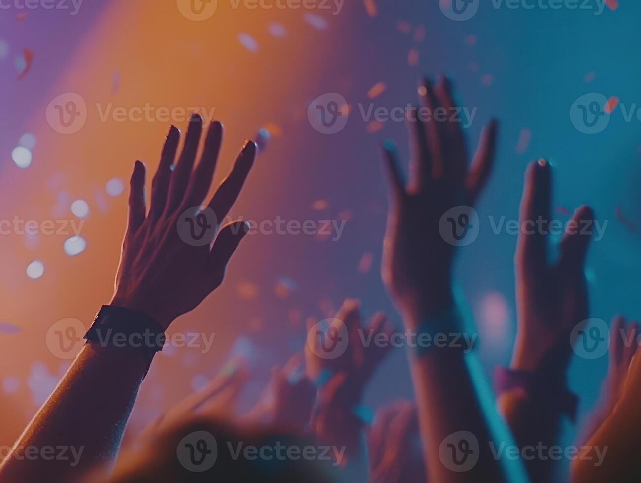 Euphoric Crowd at Concert Hands Raised High Under Neon Lights photo