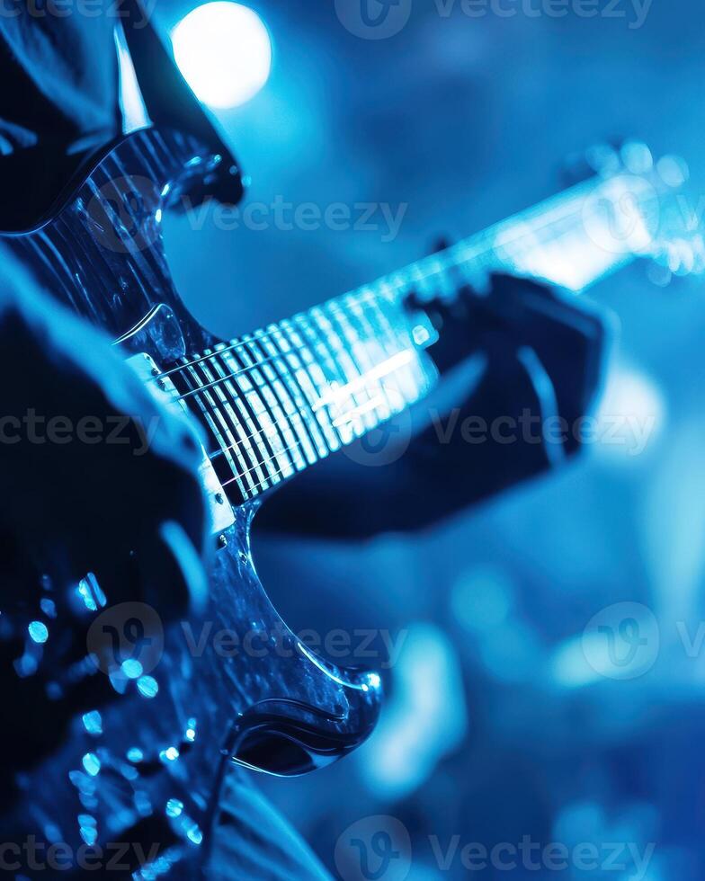 Electrifying Guitar Performance Under Blue Stage Lights A Captivating Close-Up photo