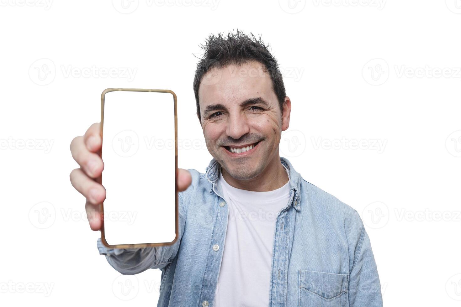 Smiling man holding a smartphone in front of a white background showcasing digital communication photo