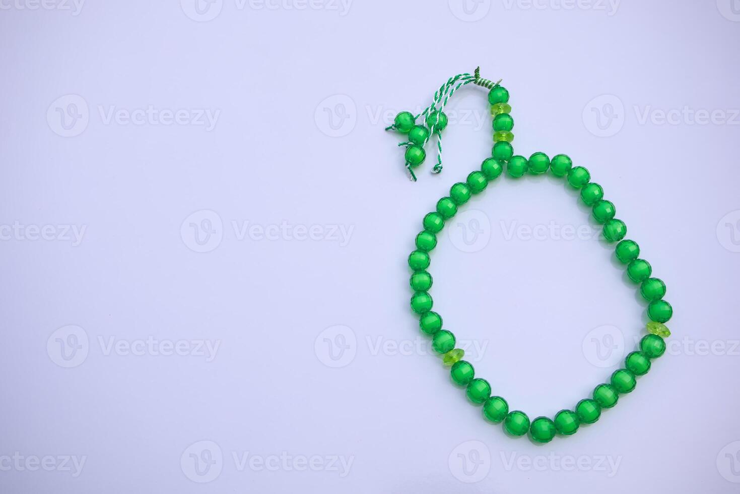 Flat Lay of Muslim Prayer Rosary Tasbih, Misbaha on Clean White Surface photo