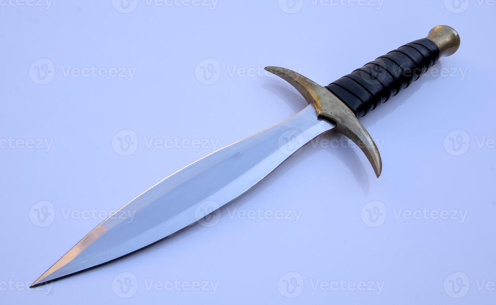 Dagger Double Edge Hunting Knife Isolated with Brass Guard and Leather and Wood Handle photo