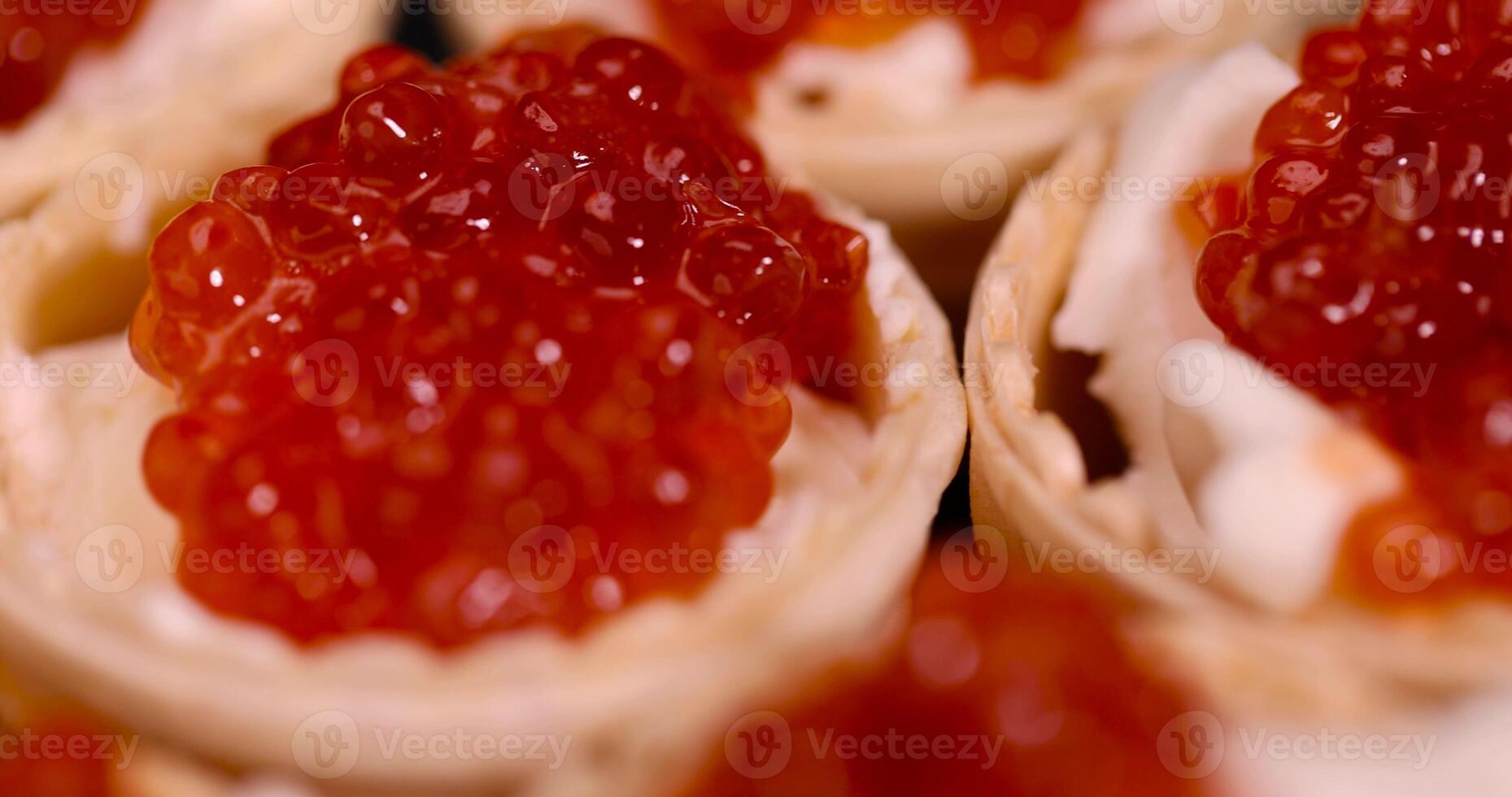 a quick snack from a waffle cup with buttercream and natural red caviar photo