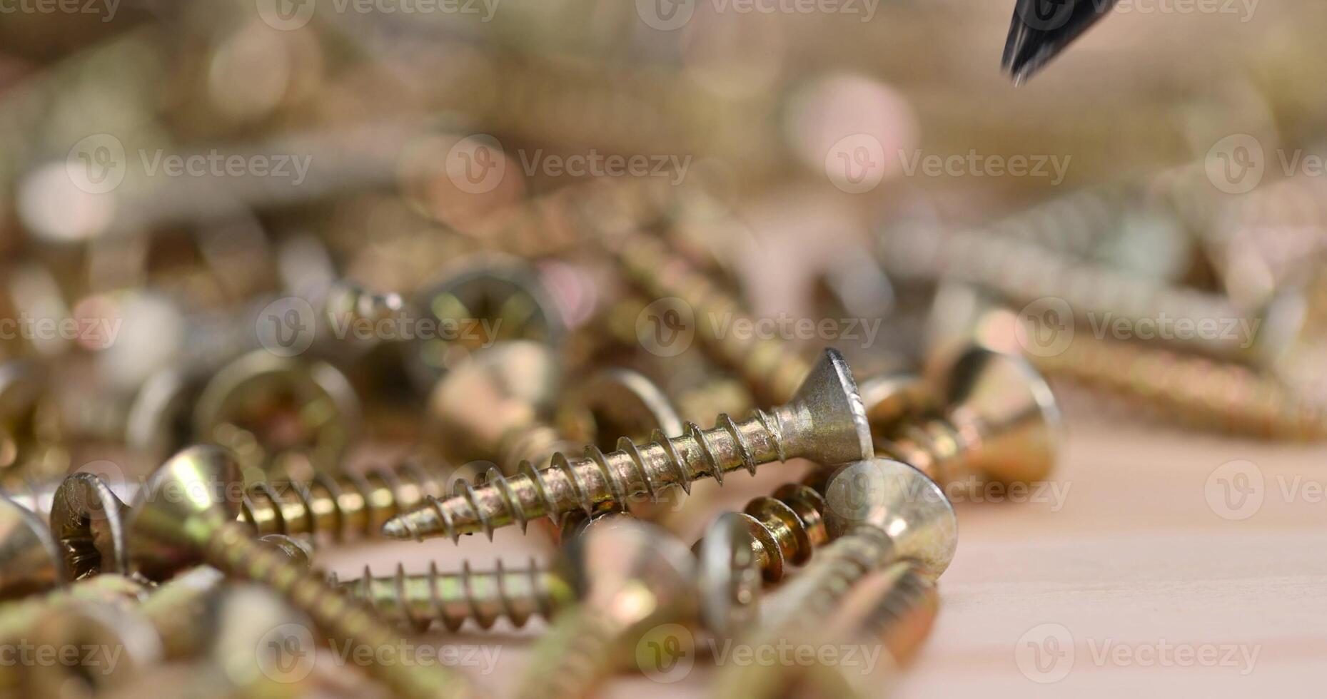 yellow metal self tapping screws for fastening are used in construction photo
