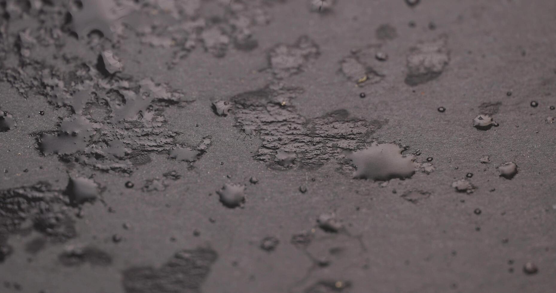 black slate surface for serving in drops of water photo