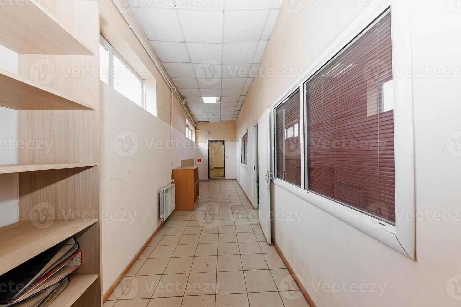 Tranquil Corridor Oasis Tiled Floors and Rectangular Panels Frame a Glimpse into Serenity. photo