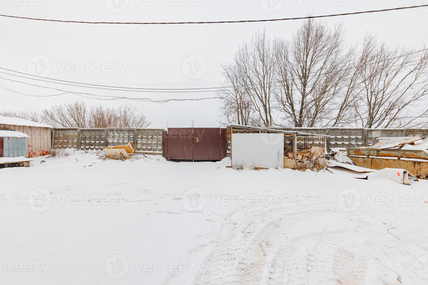 Winters Embrace A Frosted Gate Guarding a Serene Snowy Landscape, Framed by Whispering Trees. photo