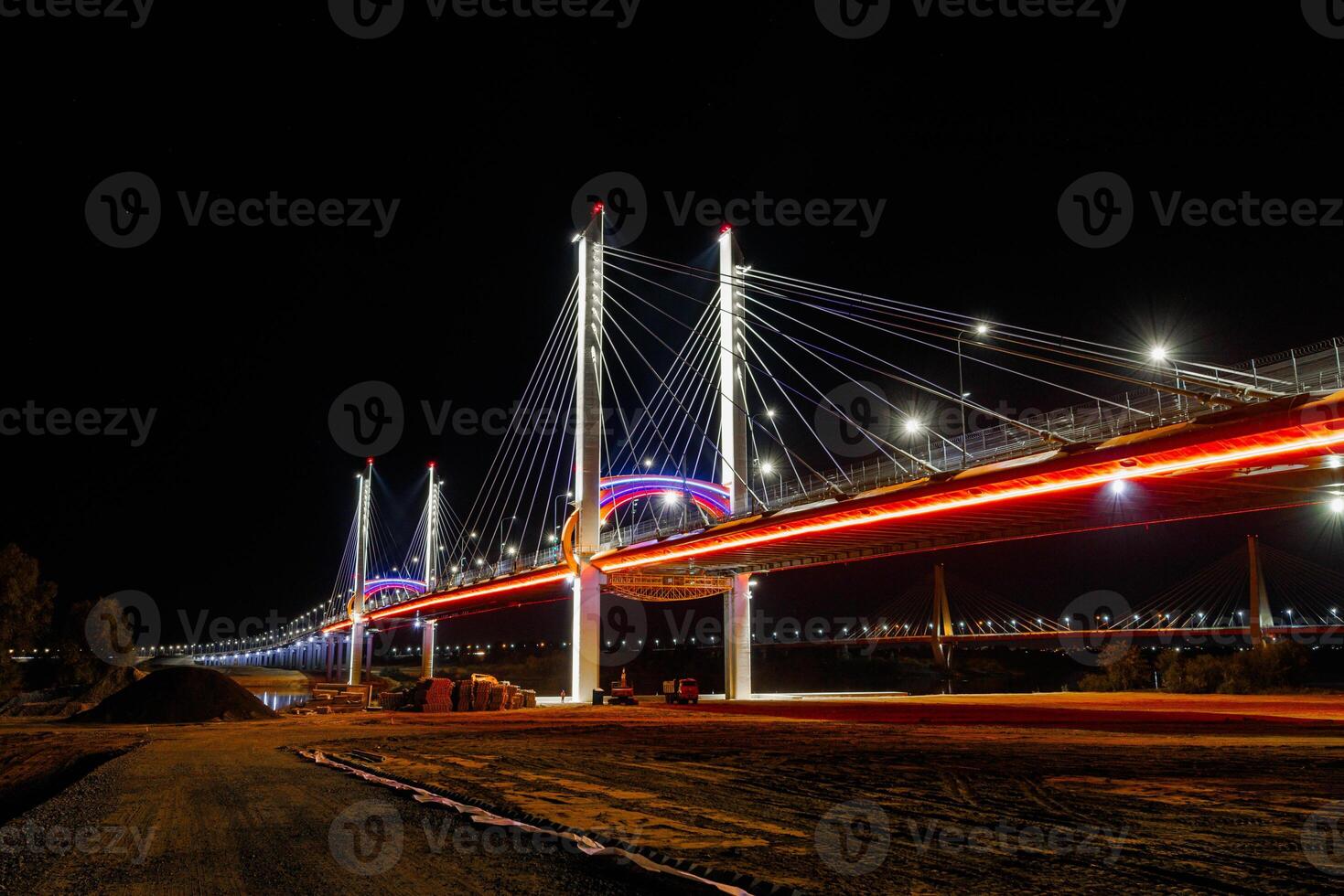 Neon Symphony A Nighttime Dance of Light Trails Beneath the Majestic Cable-Stayed Bridge photo
