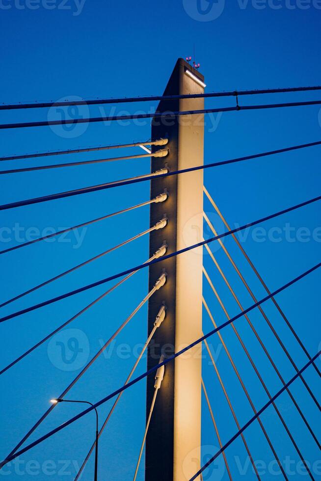 Skyward Symphony A Majestic Dance of Steel and Cables - The towering structure stretches gracefully into a boundless blue, embodying the harmony between engineering and natures canvas. photo
