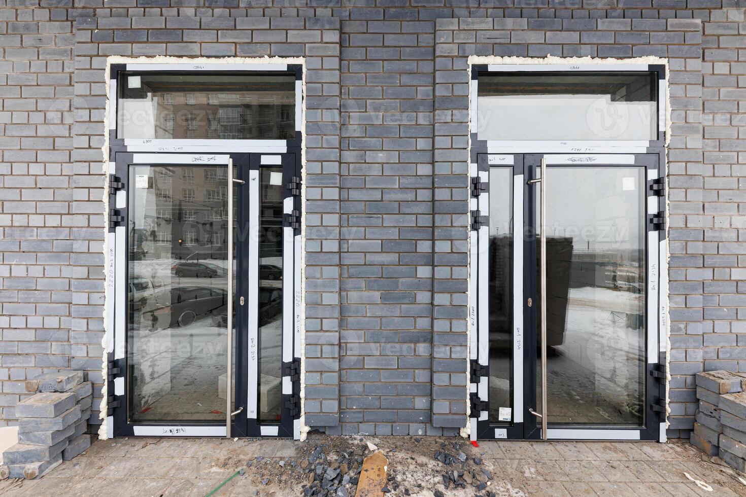 Transitional Transparency A Glimpse of Progress Behind Glass Doors in an Evolving Brick Landscape photo