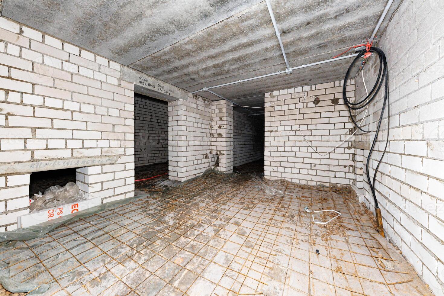 Hidden Potential An Unfinished Basement with Exposed Brick and Concrete, Awaiting Transformation Among Scattered Debris. photo