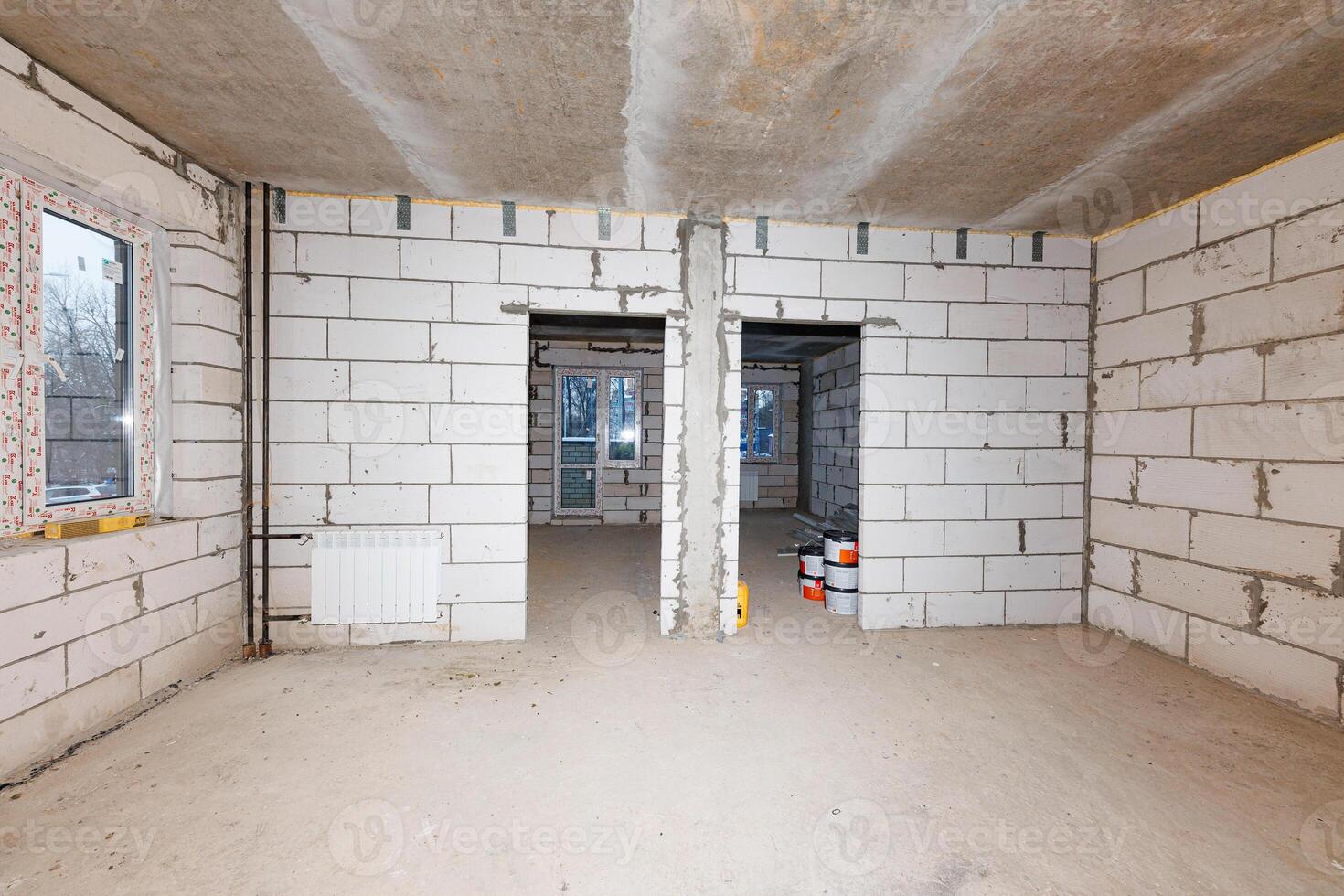 Transformation in Progress Capturing the Essence of Renovation with Unfinished Brick Walls and Paint Cans Awaiting Their Artistic Touch. photo