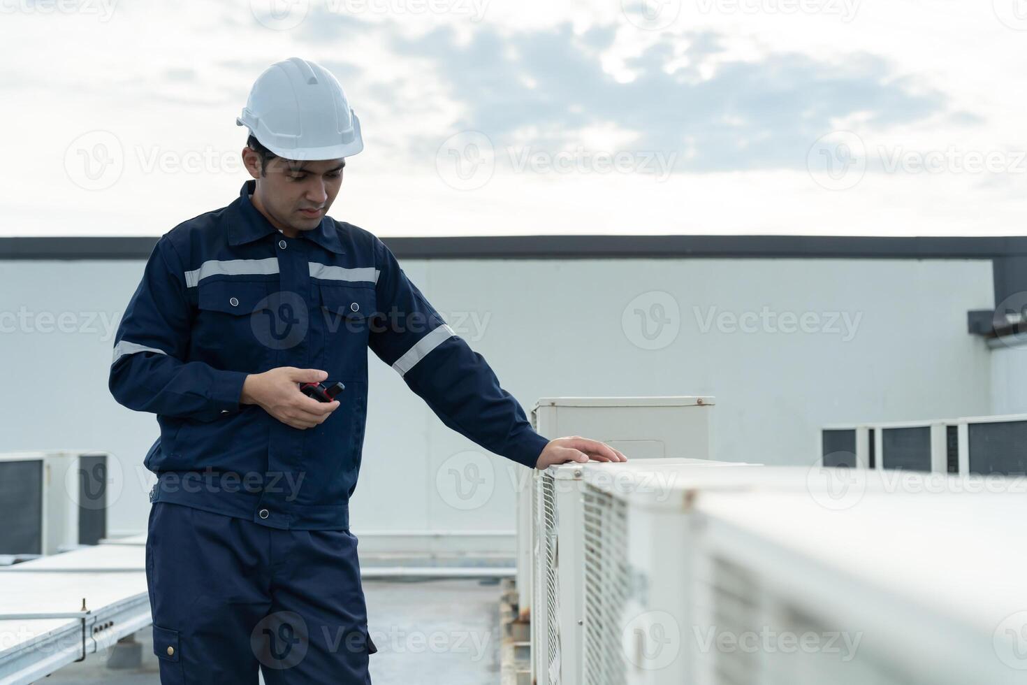 engineer work on the roof of factory. contractor inspect compressor system and plans installation of air condition systems in construction. technology, walky talky, maintenance photo
