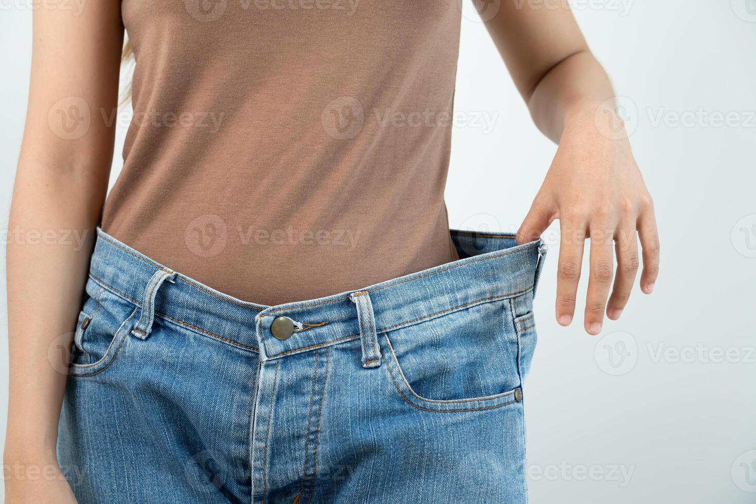 showing results of diet. Beautiful shape. female have a reduced waist size after under going a weight loss corse. can not wear jeans due to weight loss. balance, control, routines, exercise. photo