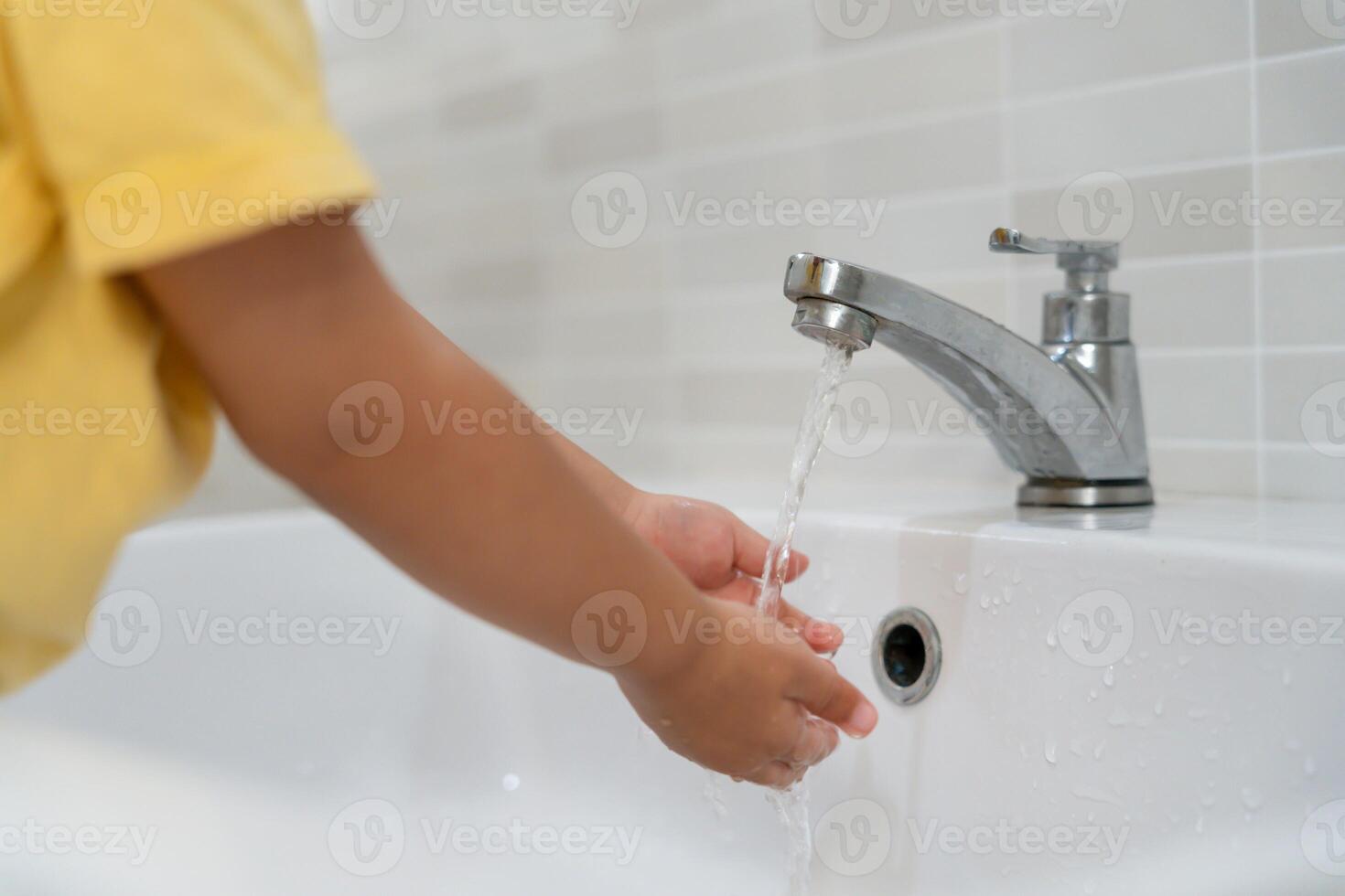 kid hands wash with soap bubbles and rinse with clean water to prevent and stop the spread of germs after back to home, virus or covid19. Good health and good personal hygiene, virus, bacteria photo