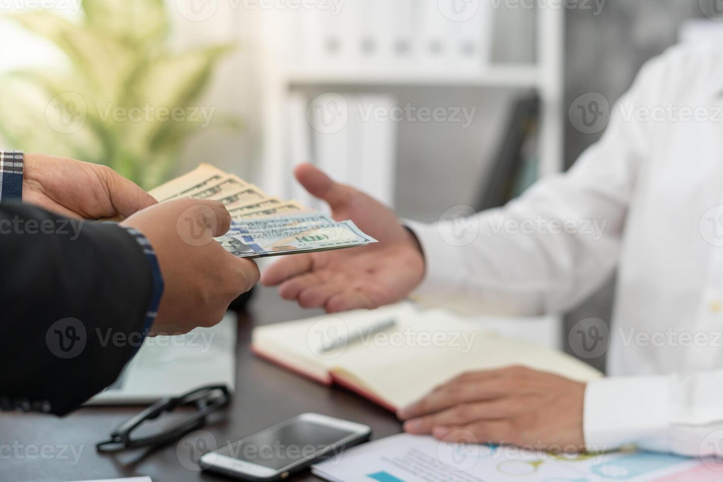 salary or bonuses from management or Boss. Company give rewards to encourage work. Smiling businessman enjoying a reward at the desk in the office. photo