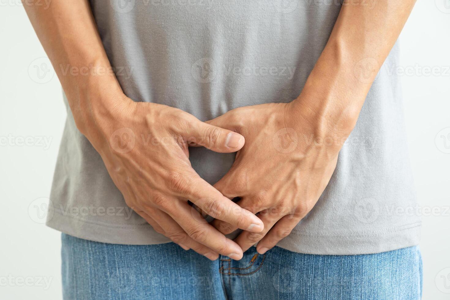 hold hand in front of private parts feeling discomfort from disease and inflammation. Venereal, testicular cancer. bladder problems, erectile dysfunction, premature ejaculation, prostate cancer photo