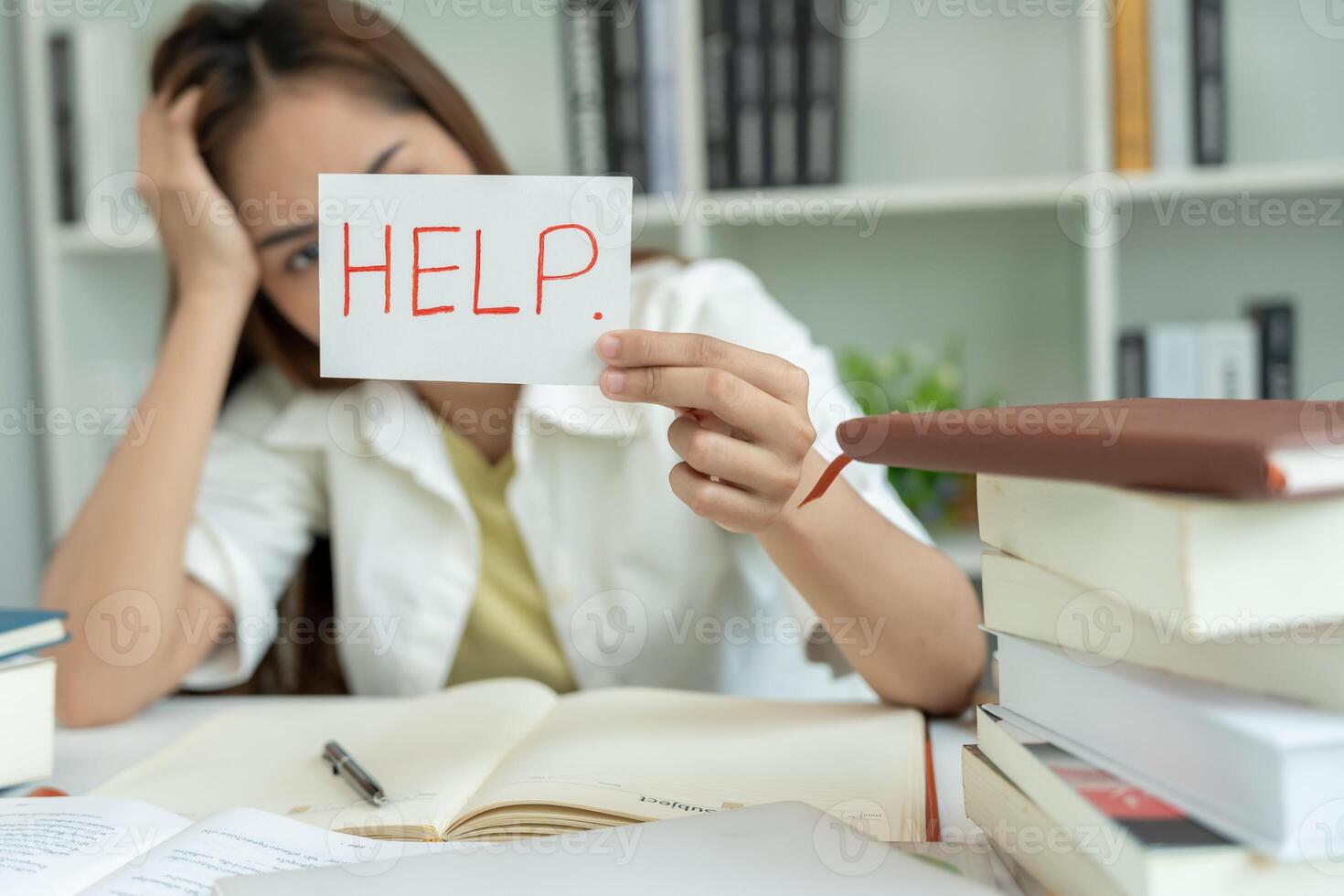 Asian student woman have anxiety because of exams, female hold help in the library. stress, despair, haste, misunderstanding reading, discouraged, expectation, photo